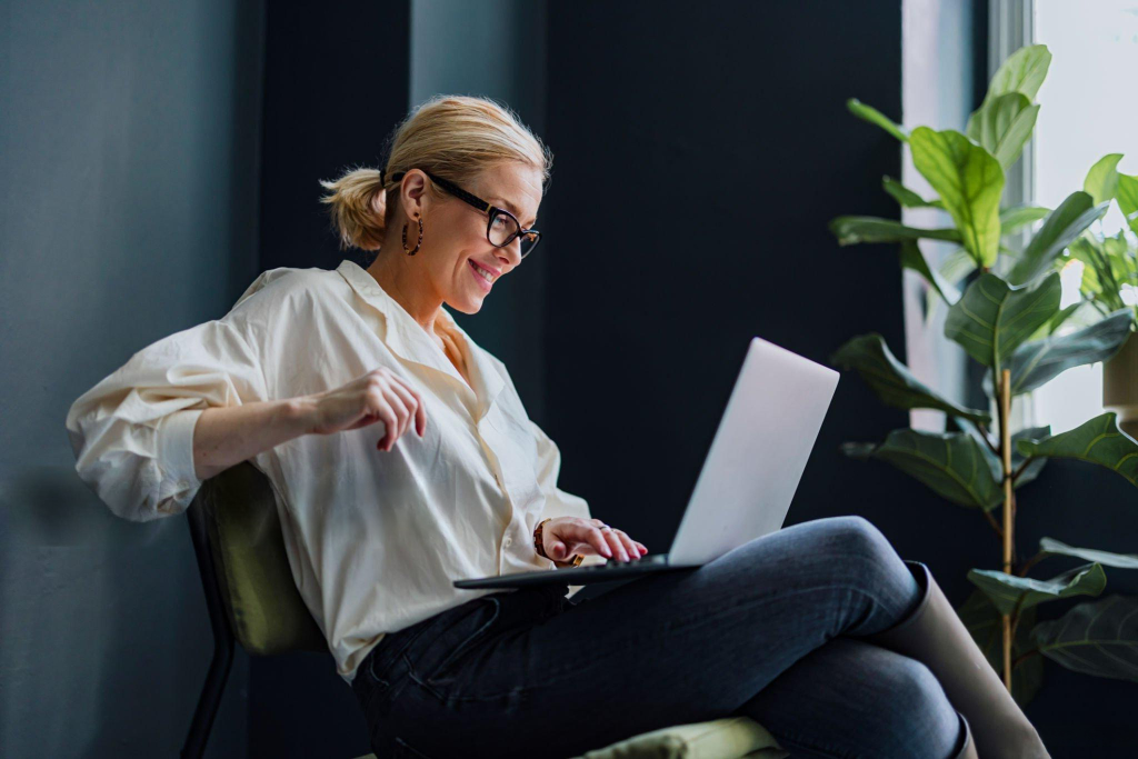 Professional reviewing screening information on a laptop